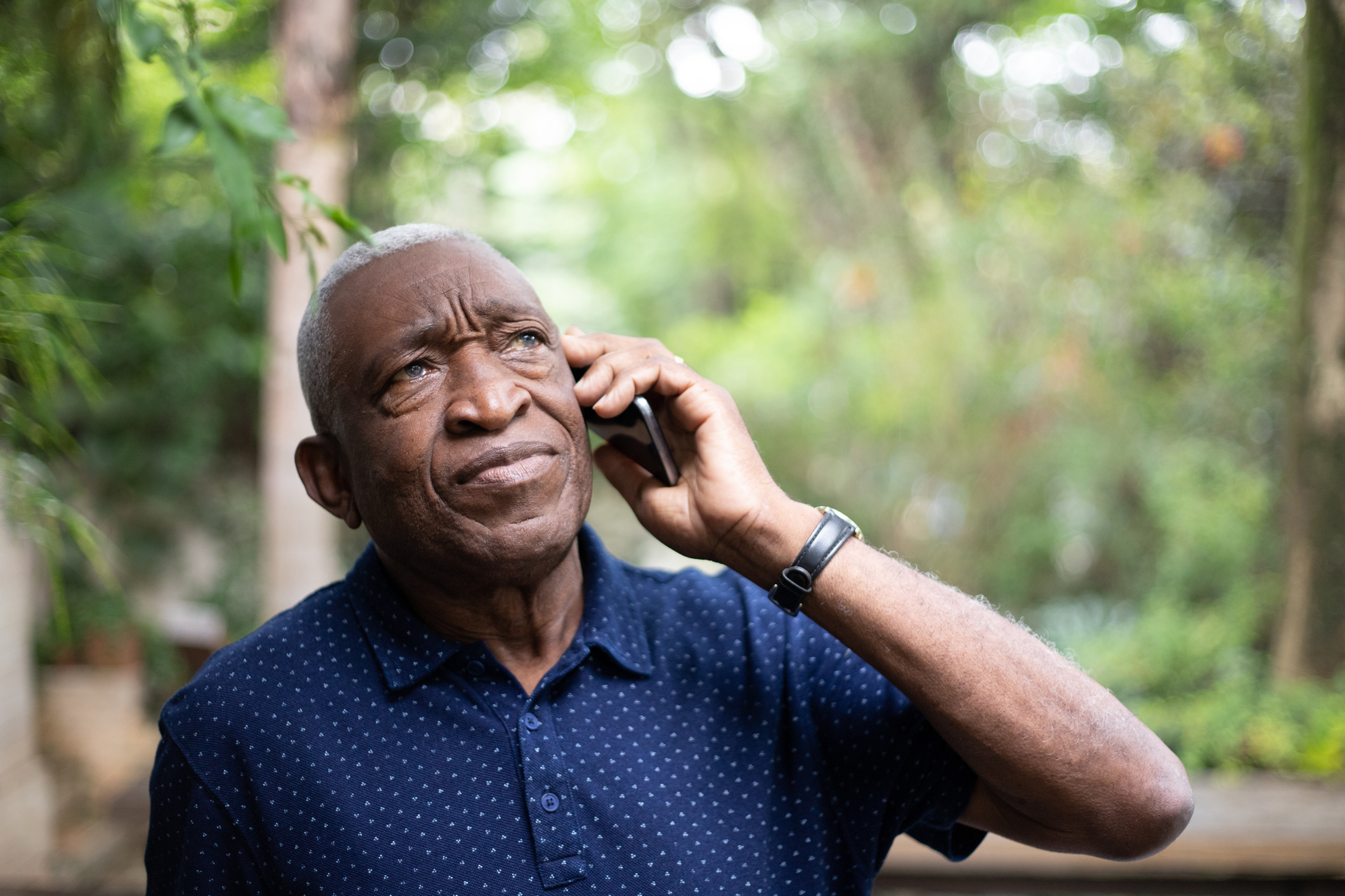 African american senior male listening to phone call