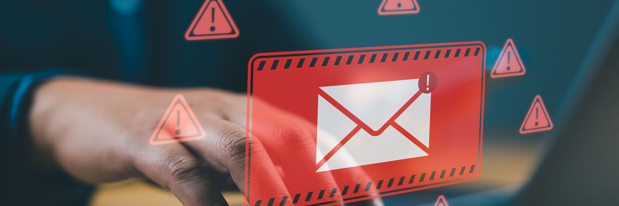 man working on computer with red email alerts