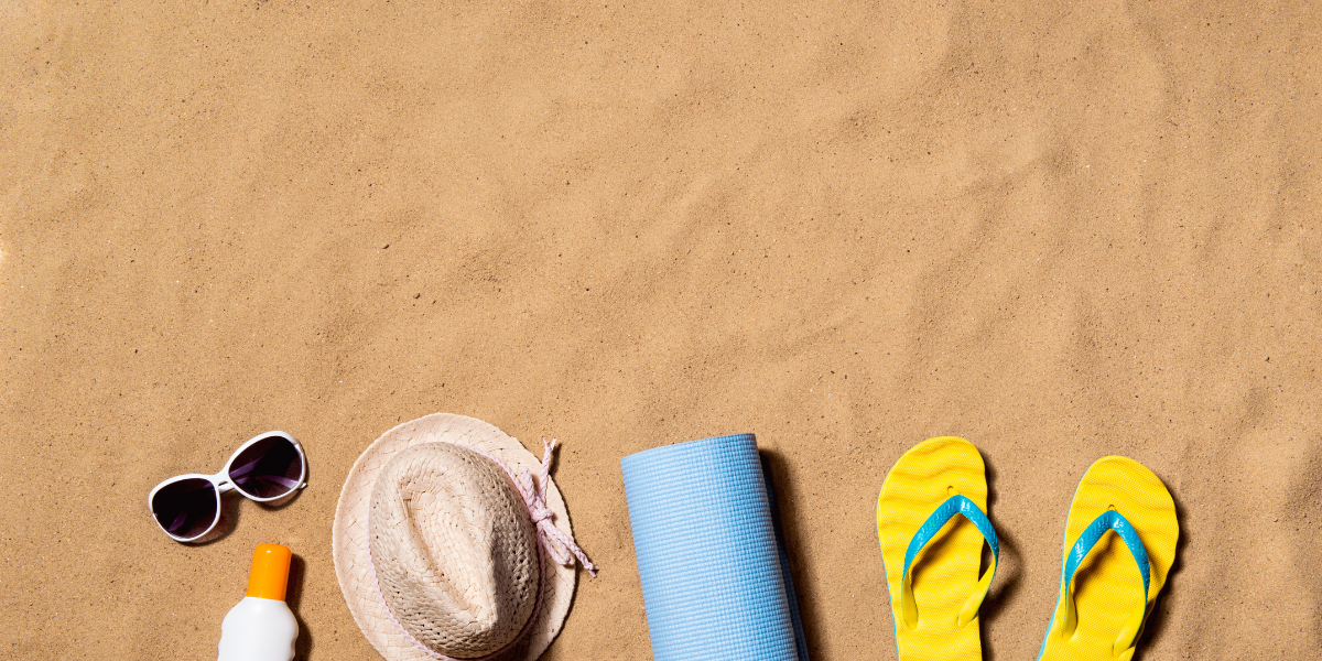 sand with hat and flips flops on it
