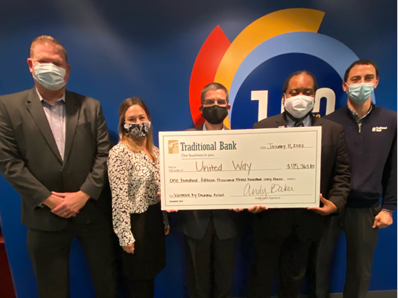 Traditional bank employees presenting check for Western ky disaster relief to united way of the bluegrass