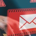 man working on computer with red email alerts