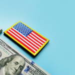 money on blue background with american flag badge